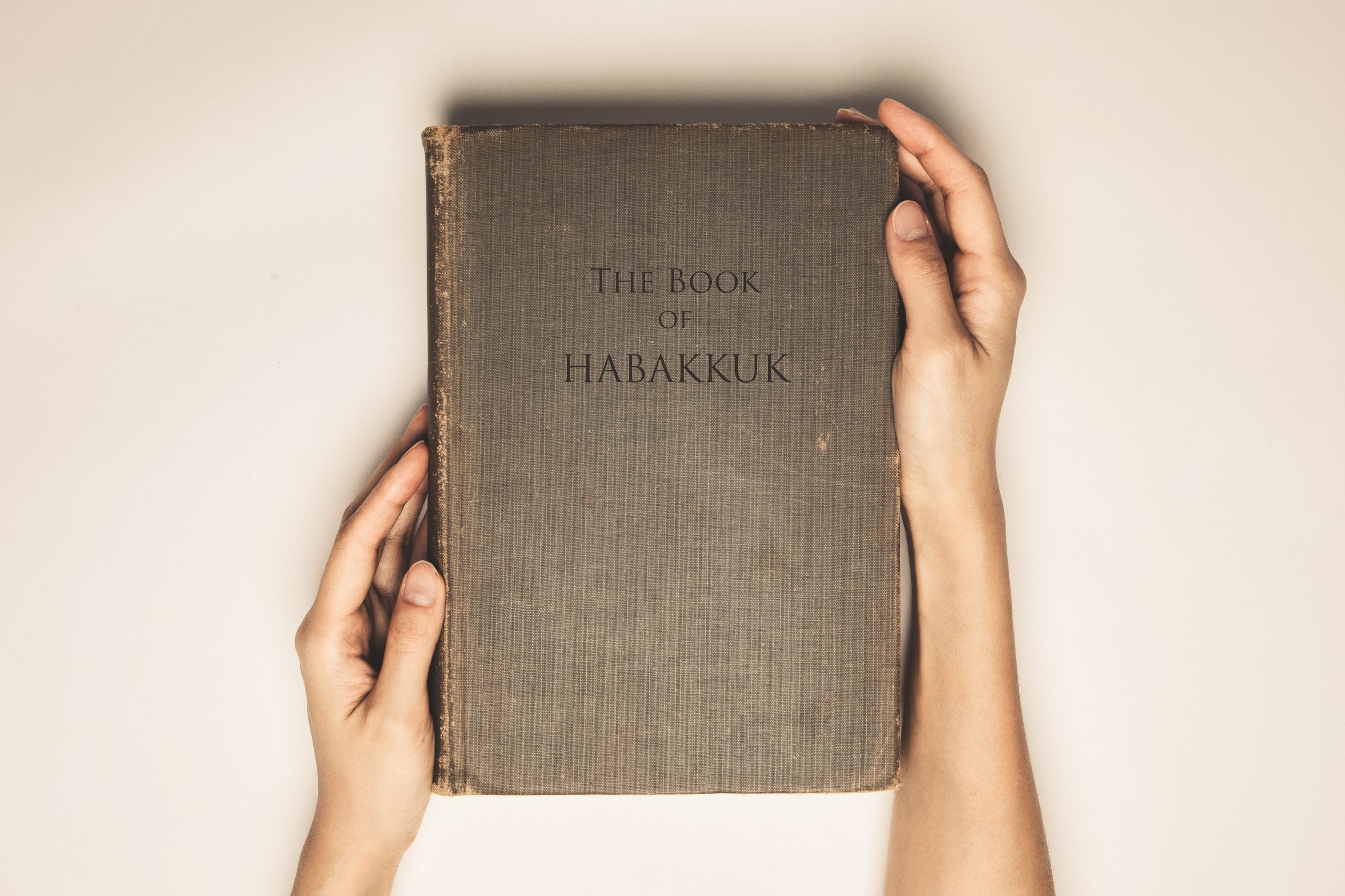 Vintage tone of hands hold the book bible of habakkuk